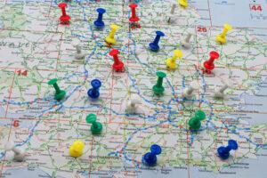 Map of the UK with coloured push pins dotted in it