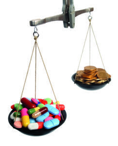 Balancing scales with medicine tablets on 1 side and coins on the other side